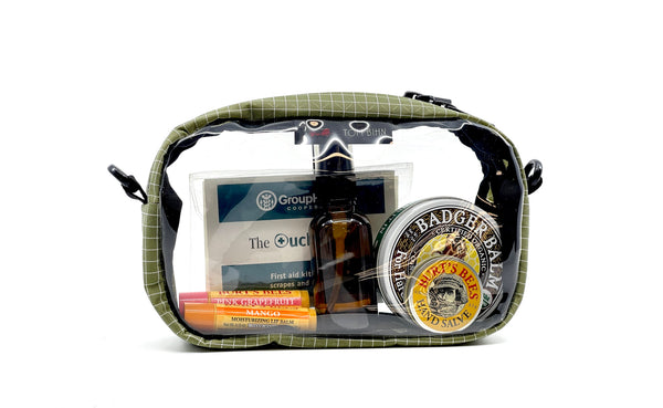 A Taiga (olive green) with white grid pattern (Halcyon) 3D Clear Organizer Cube filled with sundries.